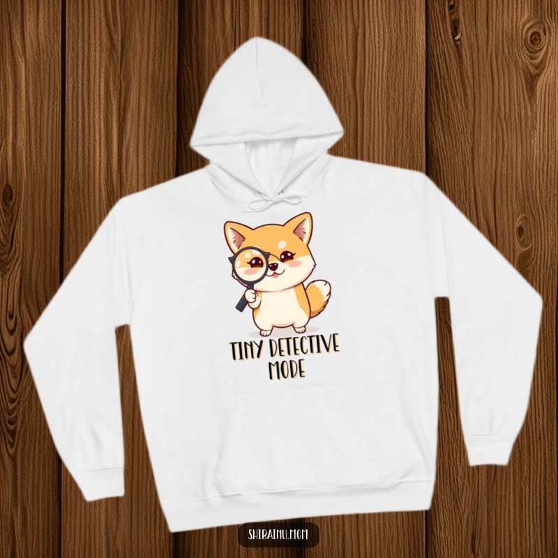 Funny Shiba Inu dog hoodie design, a Shiba Inu holding a magnifying glass, with a mischievous look, ready to investigate.